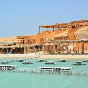 Orange Bay Hurghada beach with boats and crystal clear waters